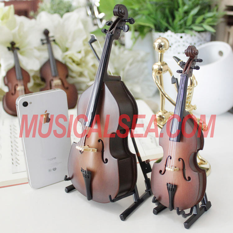 Miniature brown violin figurines with music b